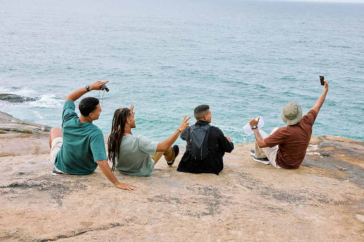 Group of people at a cliff near the sea